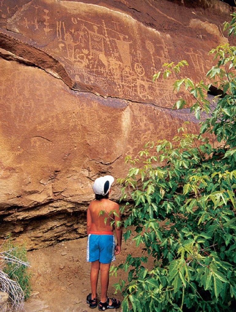 Image- Adventurous kids Discover Dinosaur Tracks and spectacular views of Native American Petroglyphs etched into rock on Potash Road-Adventure Travel