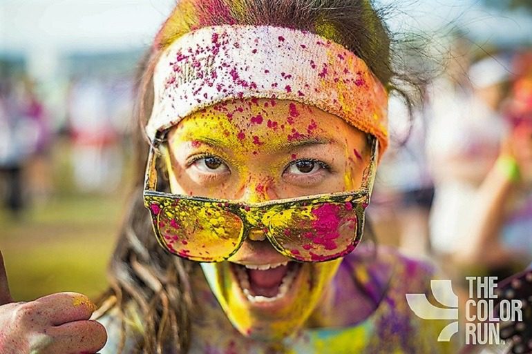 Image: After completing The Color Run, an elated Color Runner gives two thumbs up for an amazing race
