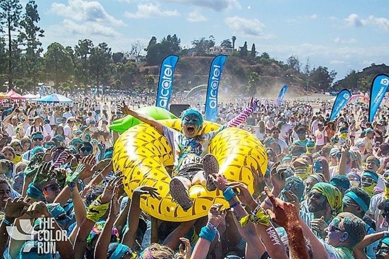Image: After The Color Run in a plum of colors, an ecstatic Color Runner celebrates at the Finish Festival