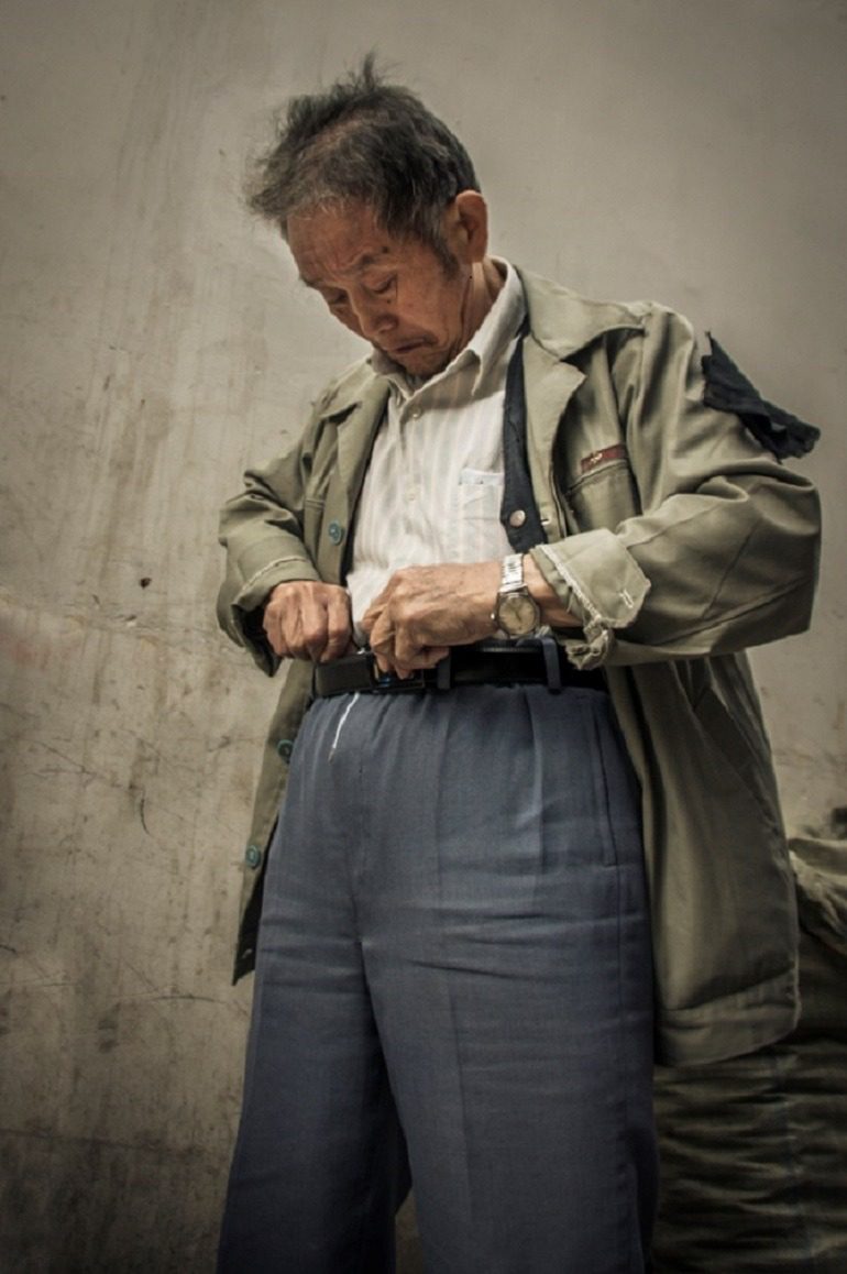 Image- Ron Gessel, the famous street photographer captures a Man pulling up his pant, ‘The Streets of Shanghai