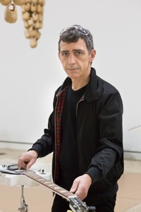 Image- In preparation for this exhibition, Céleste Boursier-Mougenot tunes a guitar. At the Peabody Essex Museum