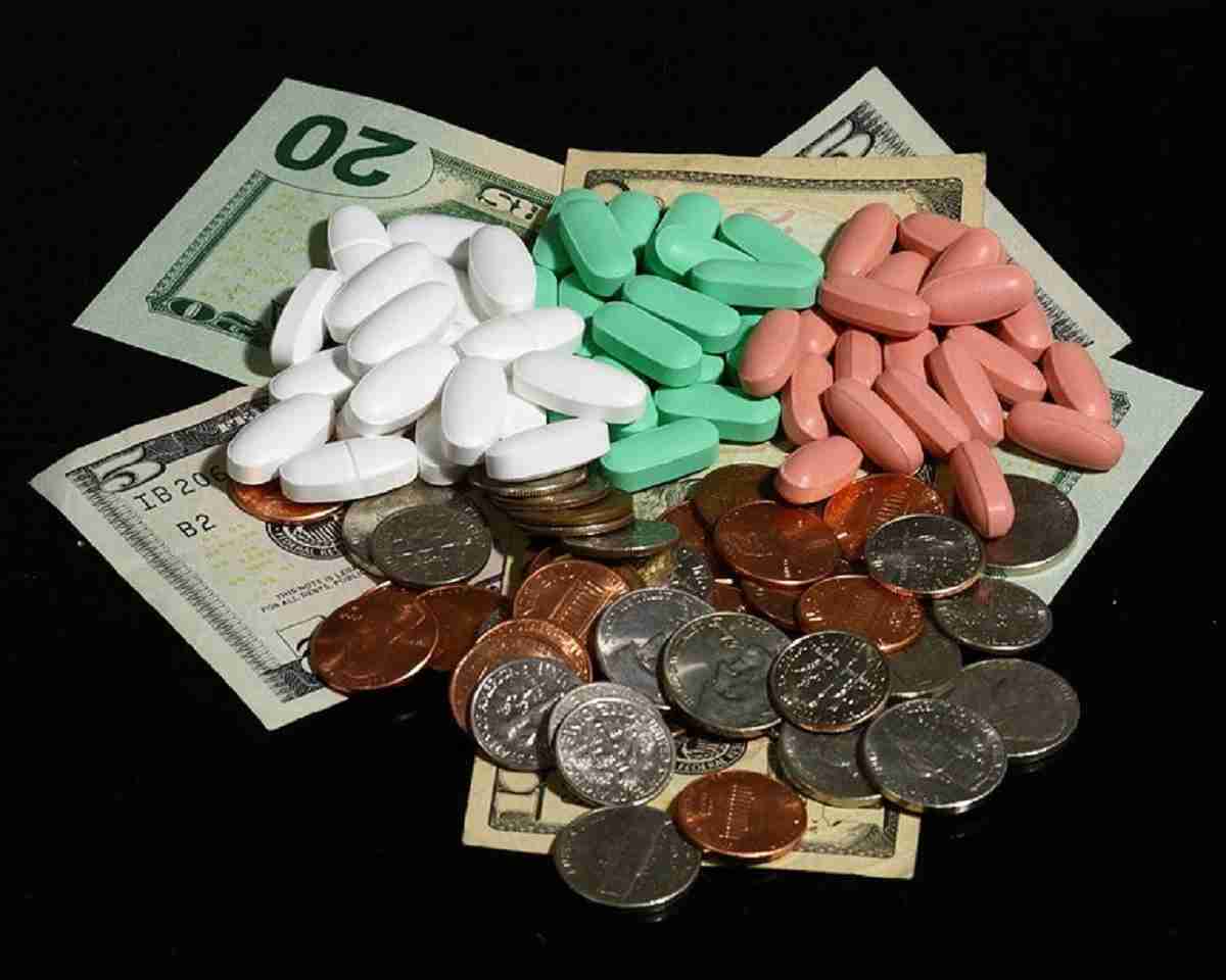 Money: pennies, dimes, quarters, and-pills. A reminder of how the Affordable Care Act also known as Obamacare will help people