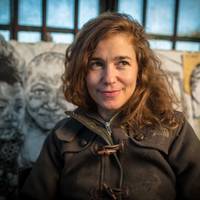 Image- Artist-portrait- Swoon in her studio, Red Hook, Brooklyn, 2013. She stands in front of her very famouse figurative prints 