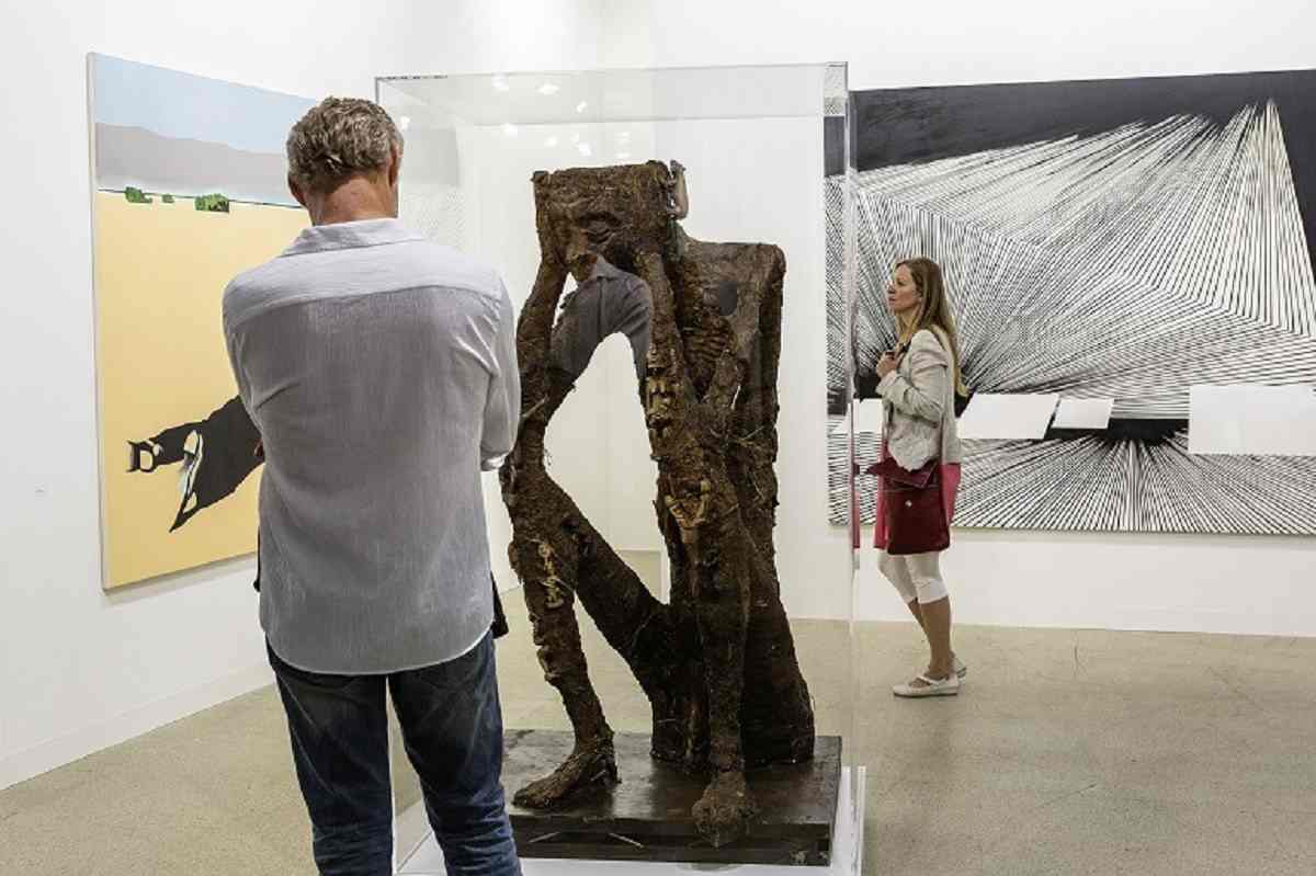 Art Basel Collectors. A Collector examines a sculpture at Foksal Gallery Foundation during Art Basel 2015-News