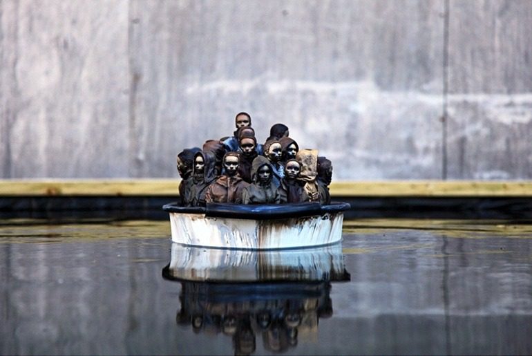 Image: Packed Migrant Boat in Dismaland by Banksy, is an important example of how the artist explores street art and graffiti art to make statements about Migration, war, liberty and other important social issues. Banksy Art