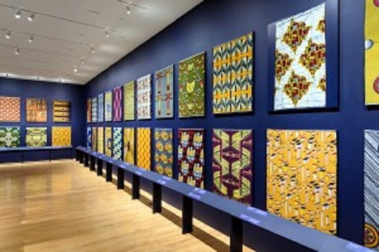 Image: Wax printed fabrics with bold patterns by Vlisco on display at Philadelphia Museum of Art is part of African identity