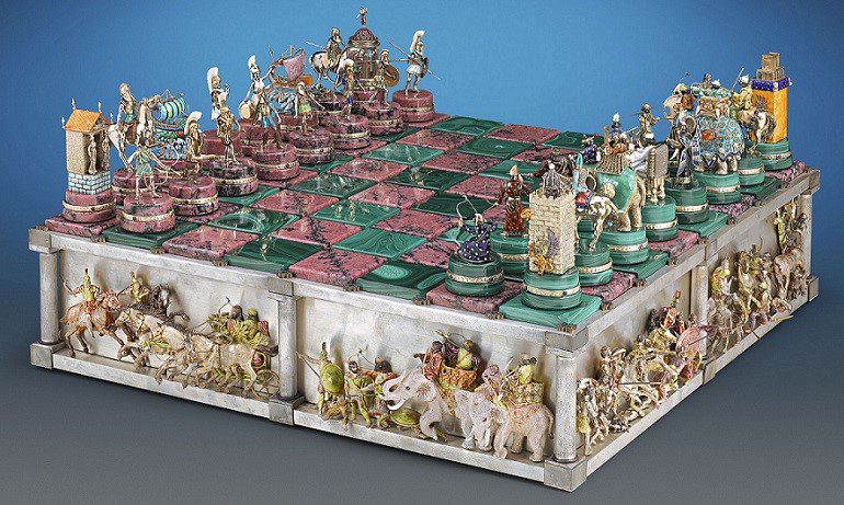 Image: The Battle of Issus Chess Set antiques crafted of 14k gold with vivid enamel and semiprecious stones, one of the antiques from M.S. Rau Antiques at the Baltimore Art, Antique & Jewelry Show