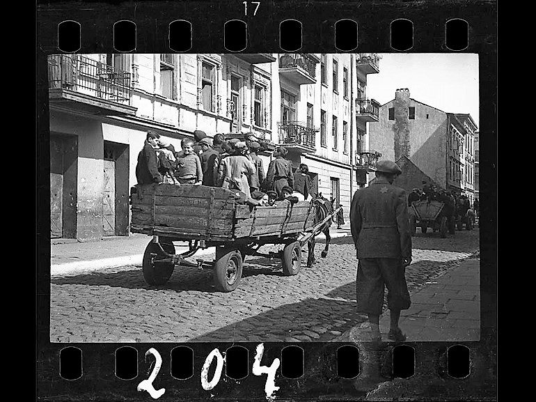 Image: Black and white photograph of Children Being Transported to Chelmno Nad Nerem, renamed Kulmhof, death camp, 1942 by photographer Henryk Ross