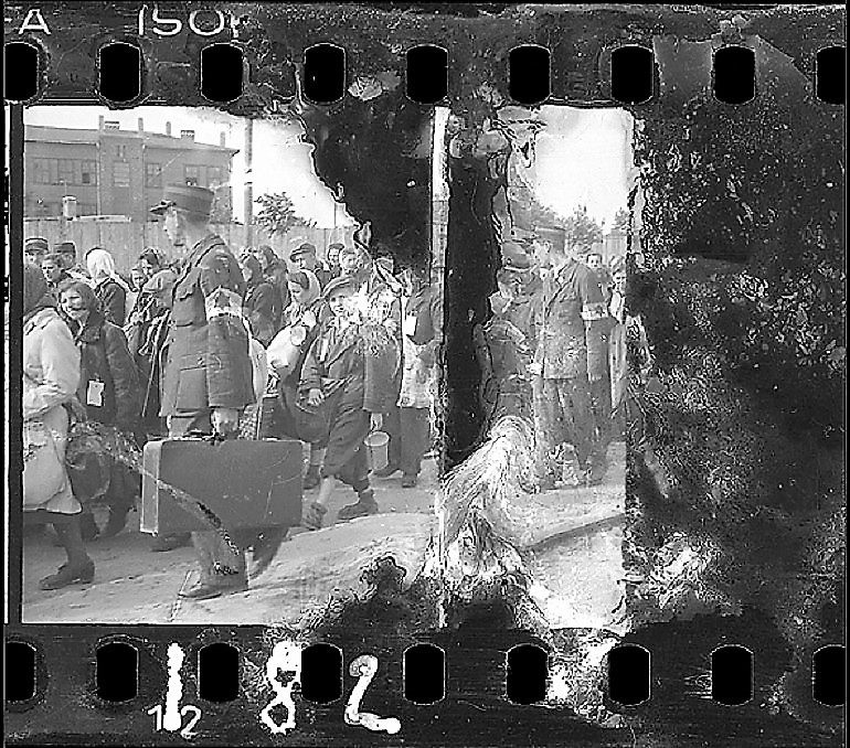 Image: Black and white photograph of Ghetto Police Escorting Residents for Deportation, 1942–44 by Jewish photographer Henryk Ross