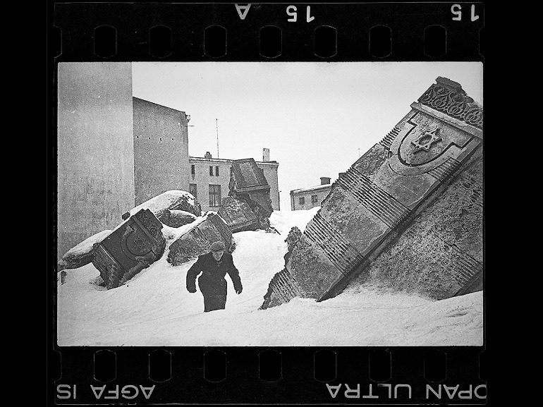 Image: Black and white photograph of Man Walking in Winter in the Ruins of the Synagogue on Wolborska Street (Destroyed by Germans 1939), 1940 by Henryk Ross