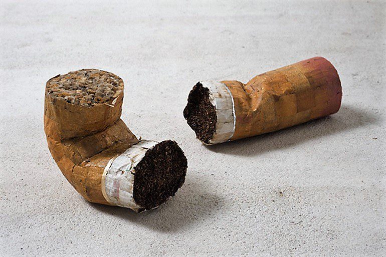 Image: A sculpture made from Cigarette butts, lipstick, glue titled Mini Colillón Masculino y Femenino by Jesús "Bubu" Negrón