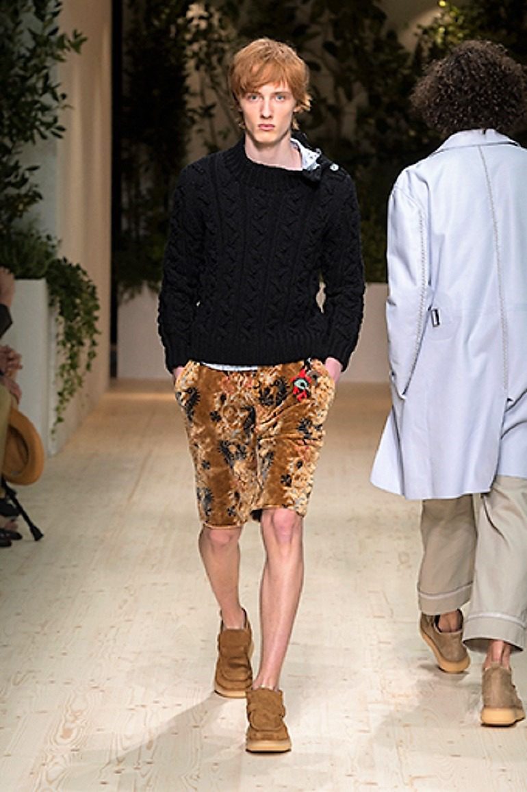 Image: A male model in flowery short and a black top on the runway during the launch of Salvatore Ferragamo Men’s Spring Summer 2018 collection -04