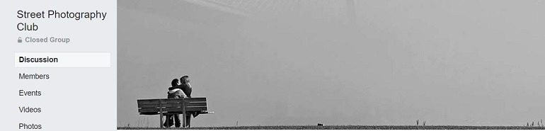 Image: A black and white photograph of two people at the beach on the banner of the Street Photography Club, one of the Facebook Photography Groups that provide Photography tutorials and photography tips for aspiring and amateur photographers