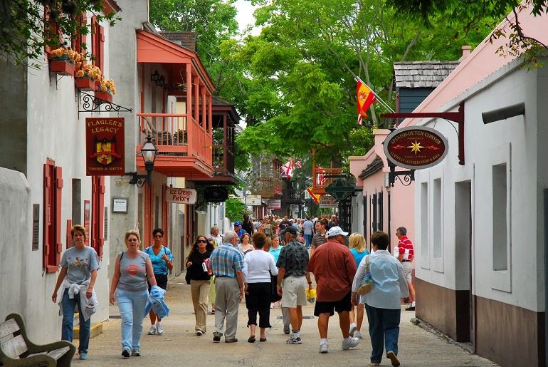 Image: Visitors leisurely walk through St. George Street in St. Augustine, Florida on a beautiful sunny afternoon 