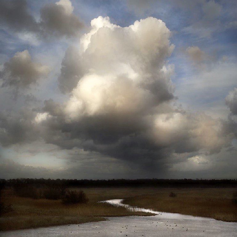 Image; Landscape photograph of a cumulus cloud over a eerie landscape by Dutch landscape photography artist Saskia Boelsums