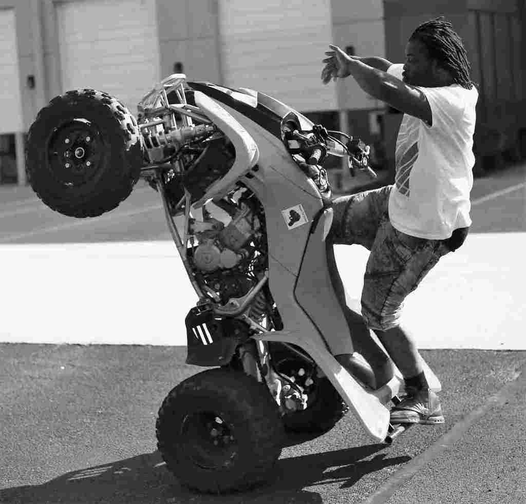 Image: Gravity, a 2019 black and white photograph of a man on an ATV in Godspeed an intimate encounter of DC Bike Life Movement 