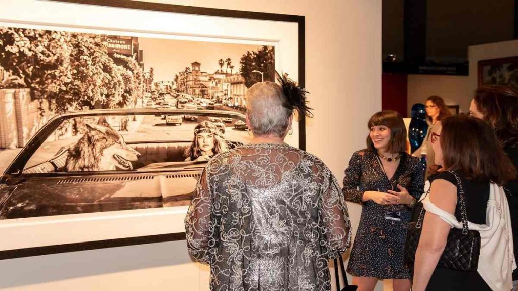 Guests at the Palm Beach Show looking at an image