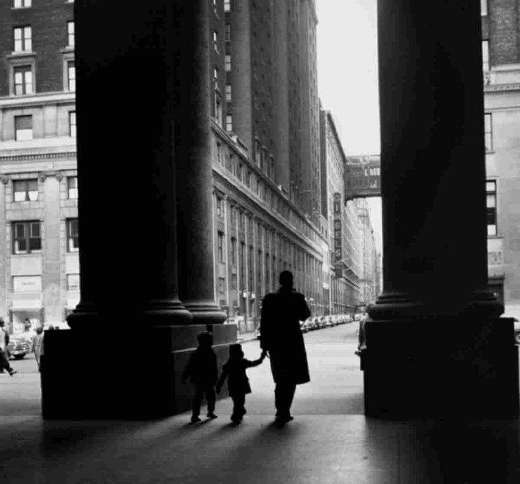 Photography of and man and two kids leaving the Penn Station by Larry Silver is in celebrating New York City