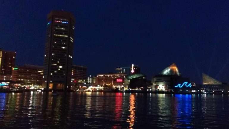 Nighttime at the Baltimore Inner Harbor presents a your guide to Baltimore, Maryland