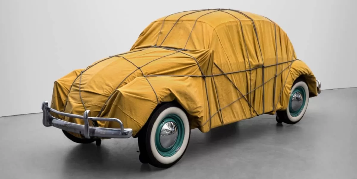 A Volkswagen Beetle Saloon wrapped in a brown canvas by Christo, is one of the sculptures Gagosian is presenting at Art Basel 2024
