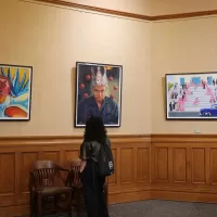 An-onlooker-viewing-artwork-Chicano-Collection Art-Exhibition at the Old Orange County Courthouse