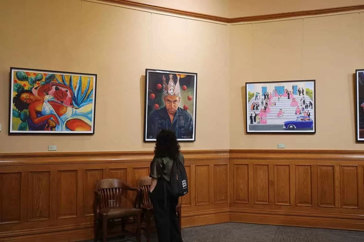 An-onlooker-viewing-artwork-Chicano-Collection Art-Exhibition at the Old Orange County Courthouse