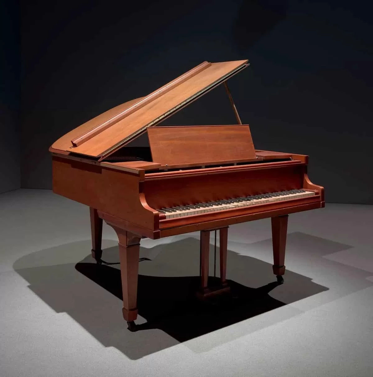 A grand piano playing music titled TEMPO RUBATO STOLEN TIME 2023 by Nikita Gale on display at the Whitney Museum of American Art