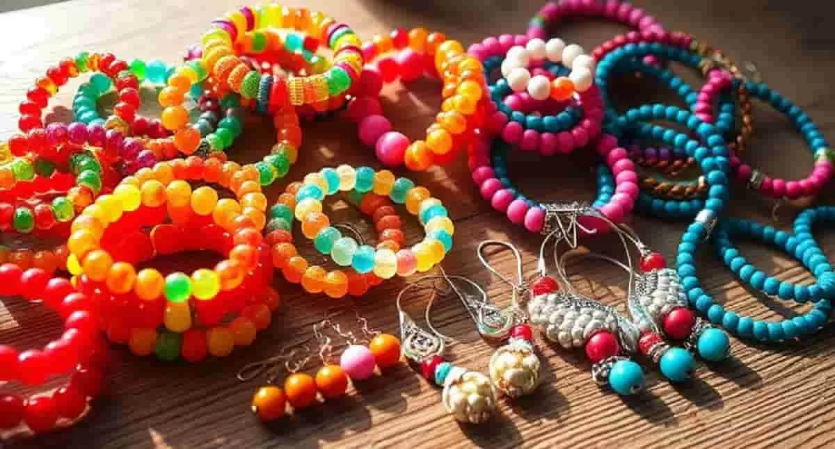 A vibrant collection of colorful beaded jewelry, including bracelets and earrings, displayed on a wooden surface with natural light highlighting the details. Beautiful jewelry ideas to make and sell