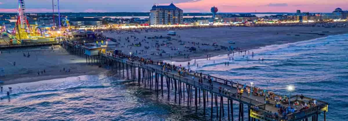 Area view of Ocean City, Maryland, including the beach with lots of people having fun and enjoying other activities. Spring break in Ocean City has activities for everyone.