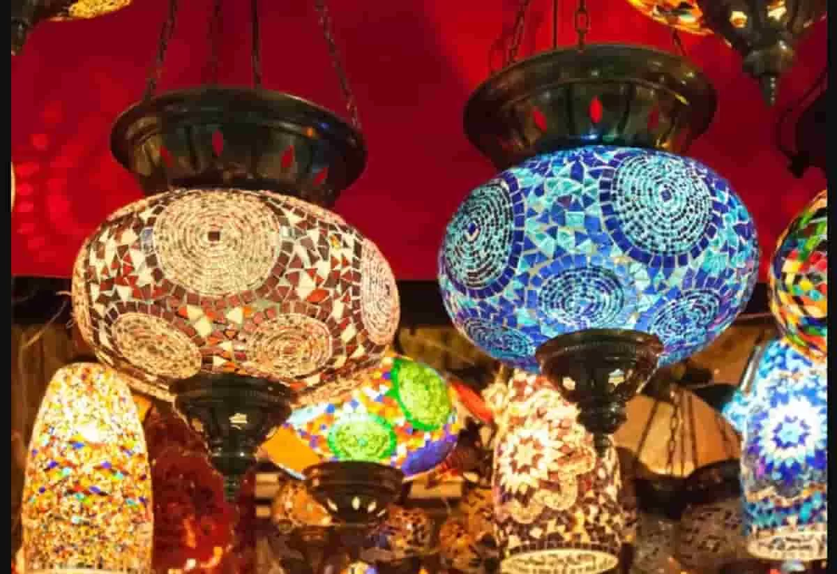 Various traditional Turkish lamps with stained glass and intricate designs hanging with three-leg chains. Securing hanging art installations like this is essential to prevent accidents.