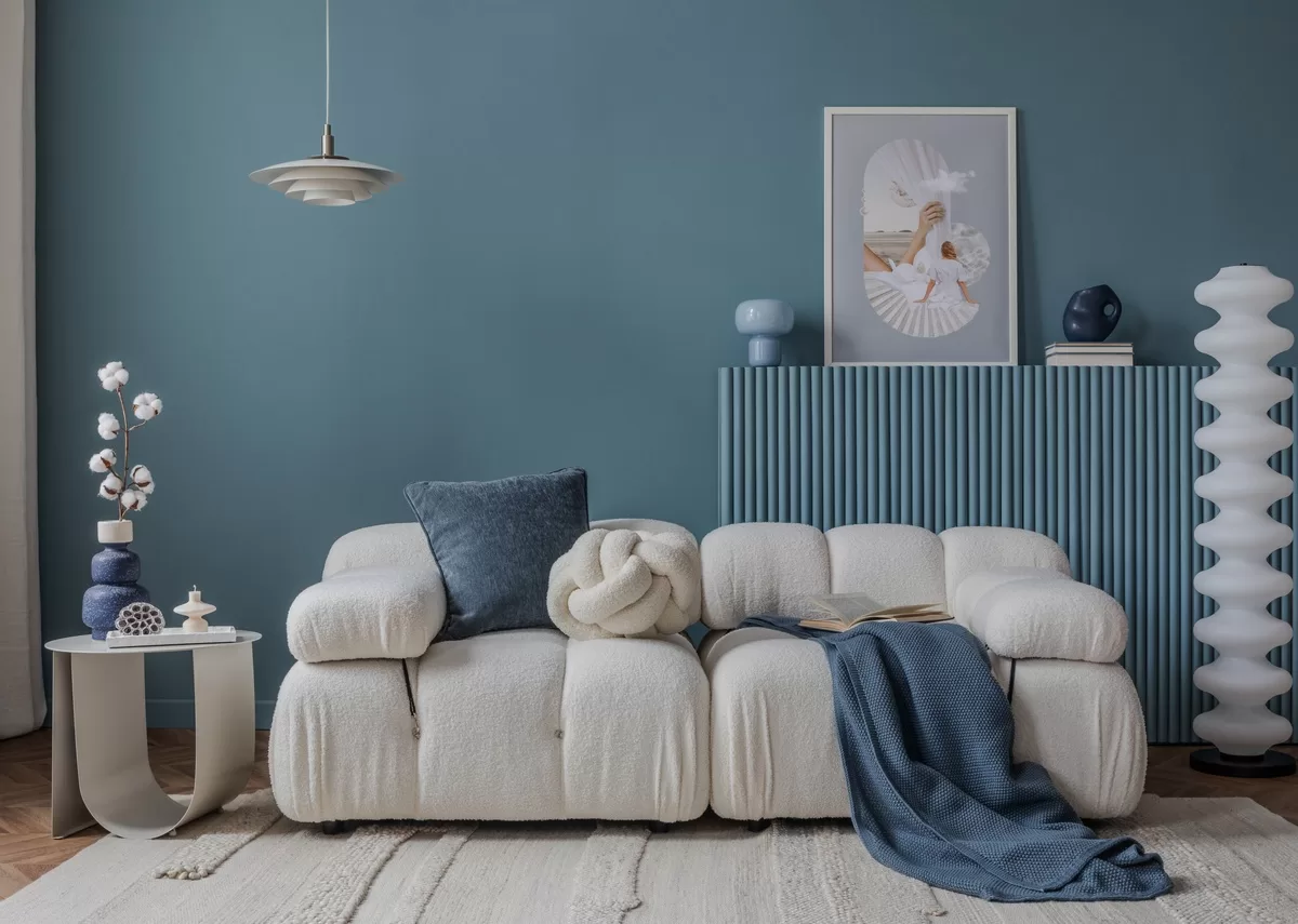 Home interior design with a minimalist style that features blue and white furniture, accent items, and pieces of art. Ways of Bringing artistic inspiration home with custom creations