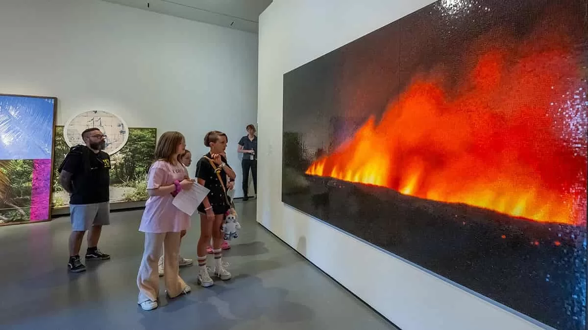 Guests and families closely look at a work of art in the Black Earth Exhibition. This Baltimore Museum of Art family guide ensures that you are adequately prepared for this experience and fun.