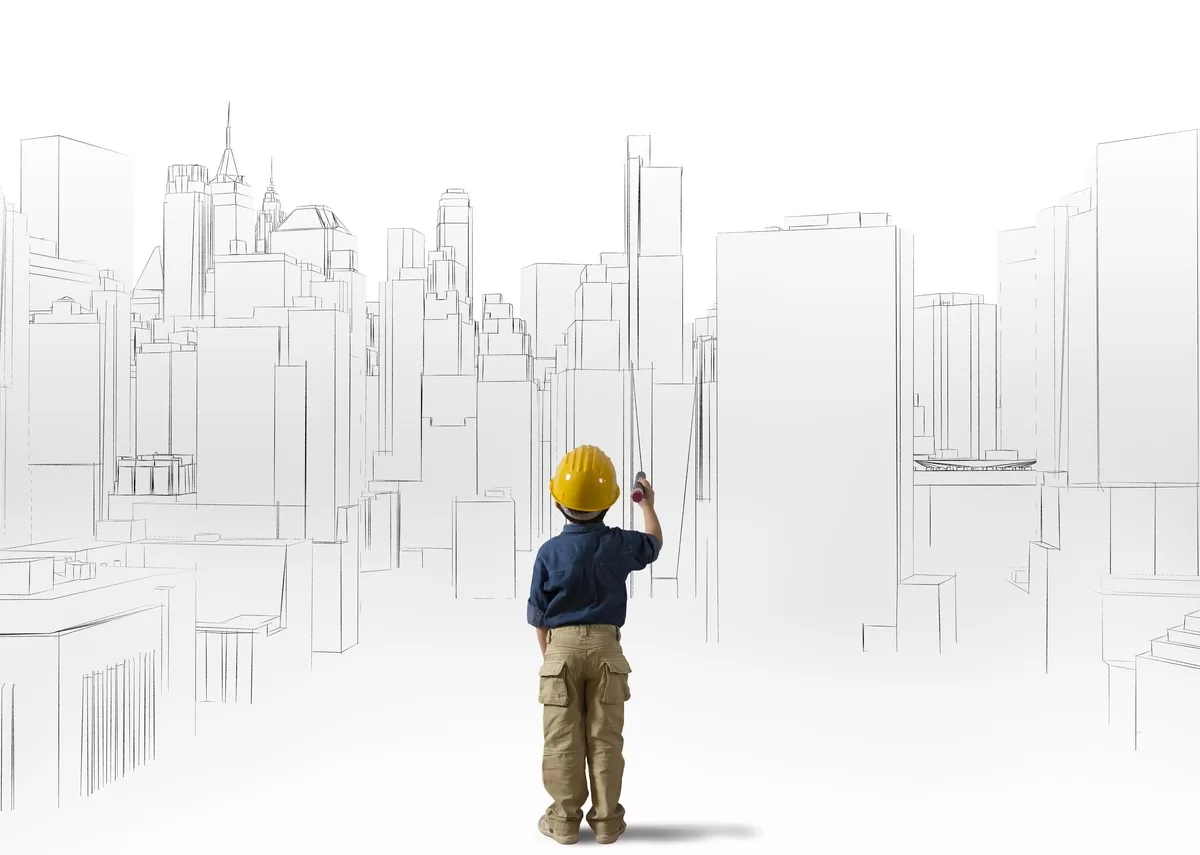 A child in a blue shirt, cargo pants, and yellow hard hat holds a marker and stands in front of a sketch of a city skyline. Engagement is one of the strategies to use art & architecture to inspire kids’ creativity