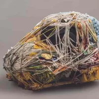 Detail of Green Monkeys Mandril, a fiber art sculpture by artist Judith Scott made from Fiber and found objects