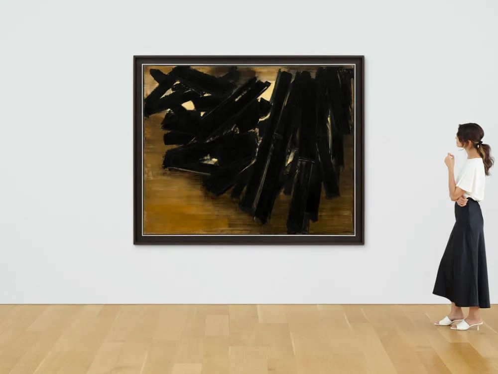 A woman views Pierre Soulages’s 1958 abstraction Peinture 161 x 200 cm, 14 Novembre 1958 at Christie's in an image accompanying the Pierre Soulages painting lawsuit.