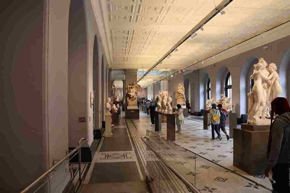 V&A Museum strike: Art lovers viewing sculptures inside the Victoria and Albert Museum in London, England, United Kingdom, during a visit to the renowned cultural institution.